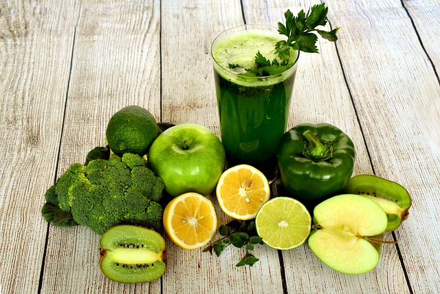 healthy diet reflected by mint juice glass surrounded by vegetables and fruits