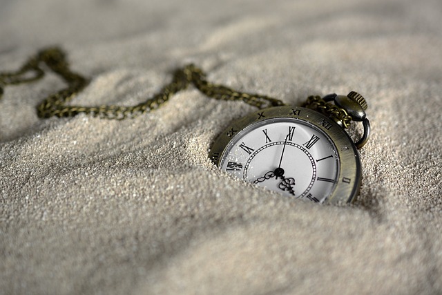 sinking watch in sand reflecting stress impact after the passage of time