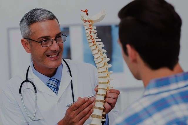 doctor explaining back pain impacts to patient