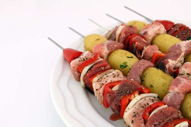 five shashlik sticks of meat and vegetables in plate for body protein needs