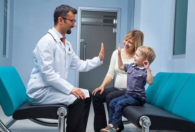 doctor with kid and mother chiropractic care