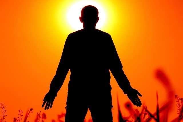 man standing looking at sunset living with arthritis