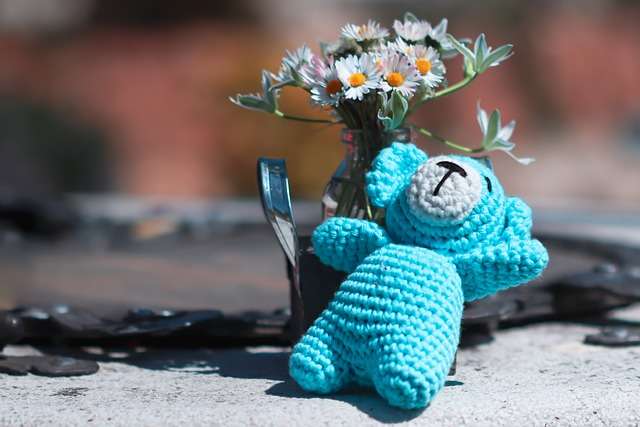 image of blue teddy bear with flower vase is your child autistic